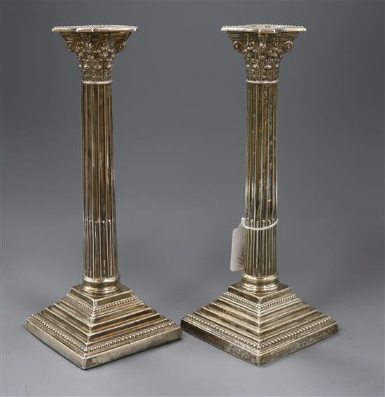 A pair of late Victorian silver corinthian column candlesticks by Walker & Hall, Sheffield, 1894, 28.5cm.